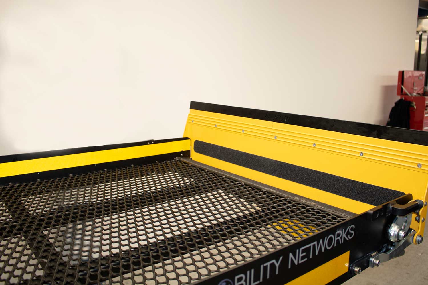 Weatherproof mesh platform and non-slip material on roll off ramp